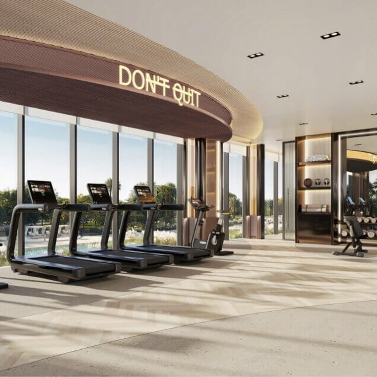 Fitness studio at Ellington Villas Dubai — a row of treadmills facing full-height windows onto the landscaped grounds